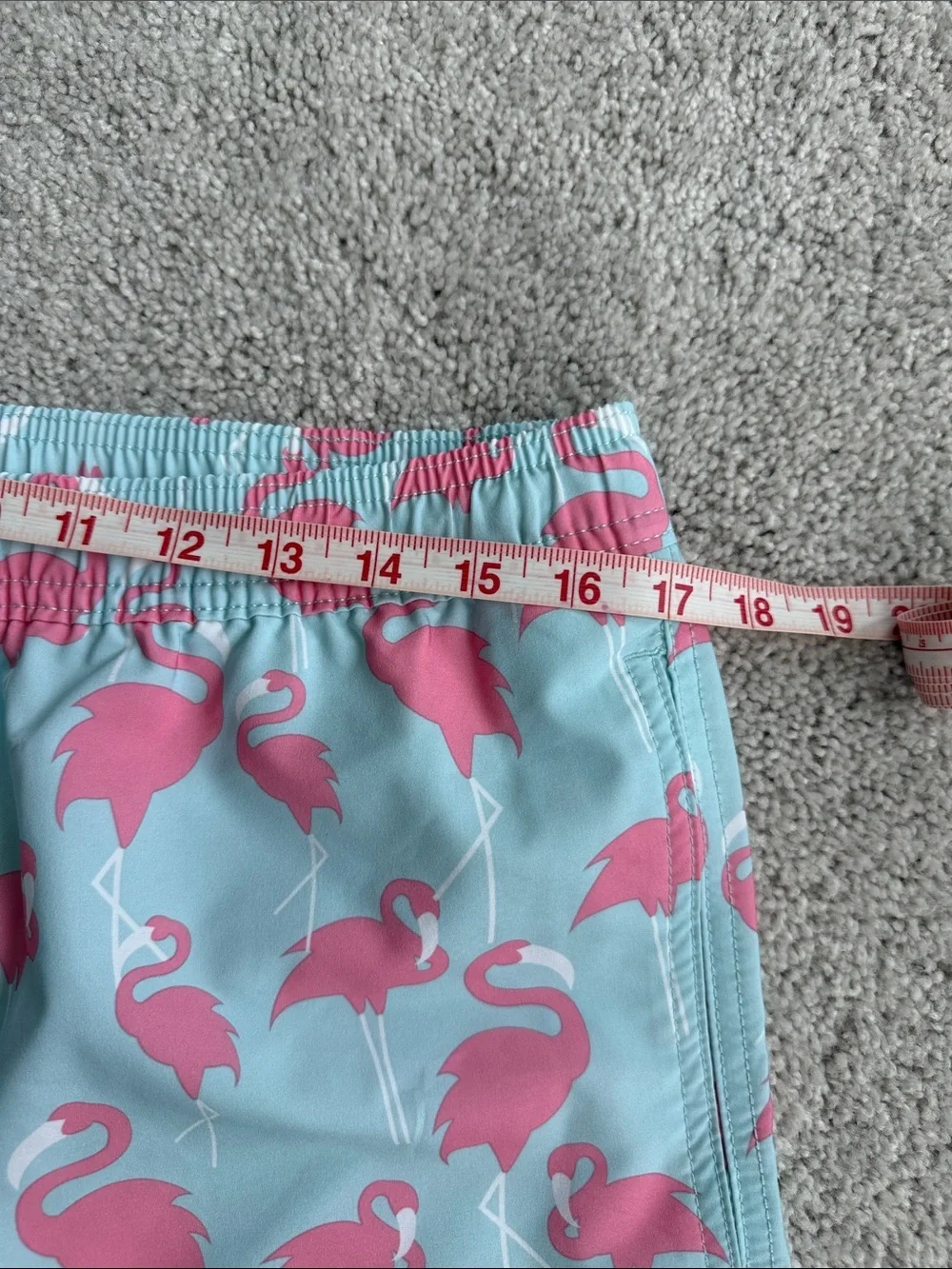 Elysian brand Men’s swim trunks in a blue and pink flamingo print- Size Medium